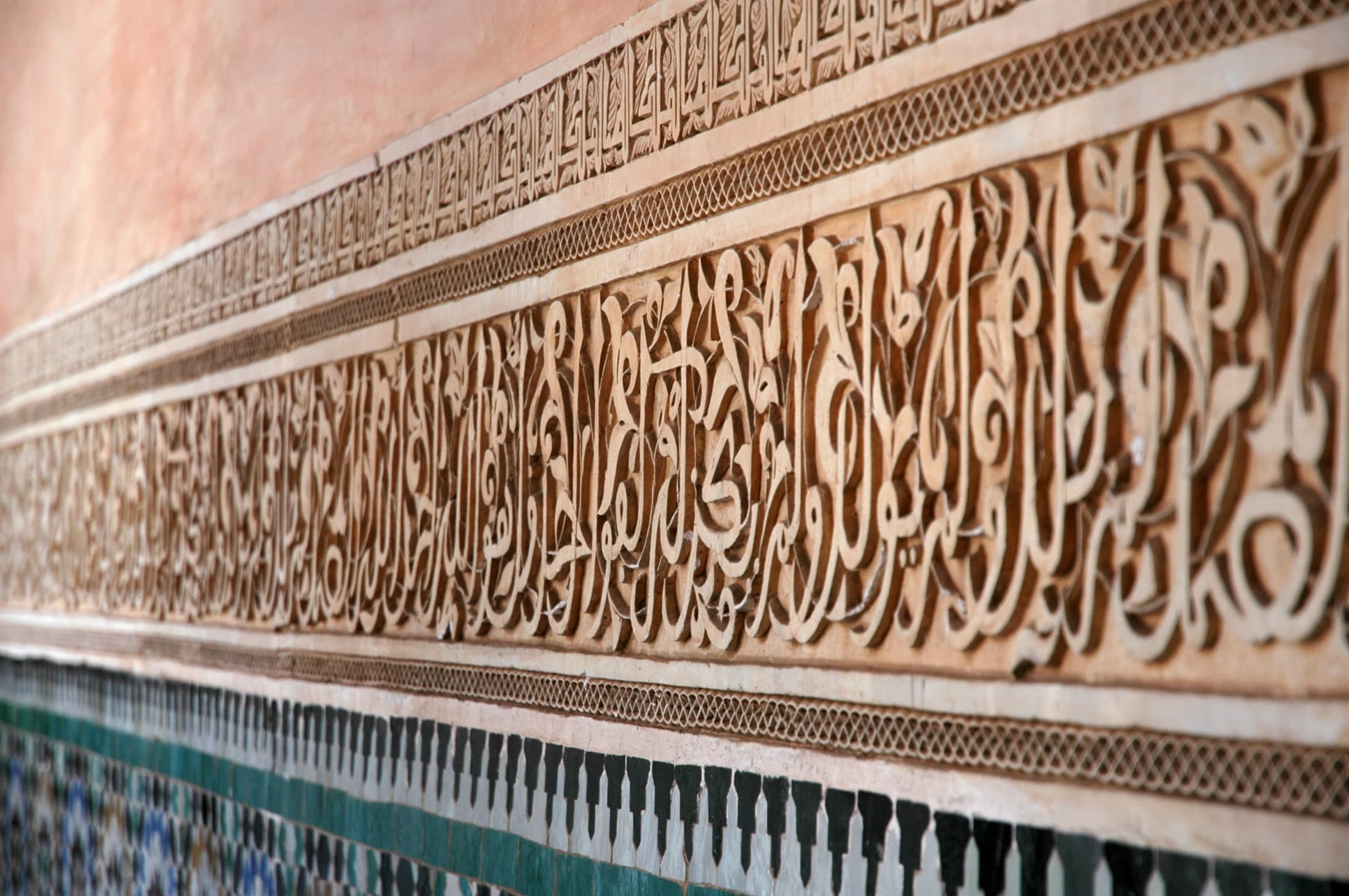 Sculpted calligraphy carved into the walls of the Medersa Ben Youssef